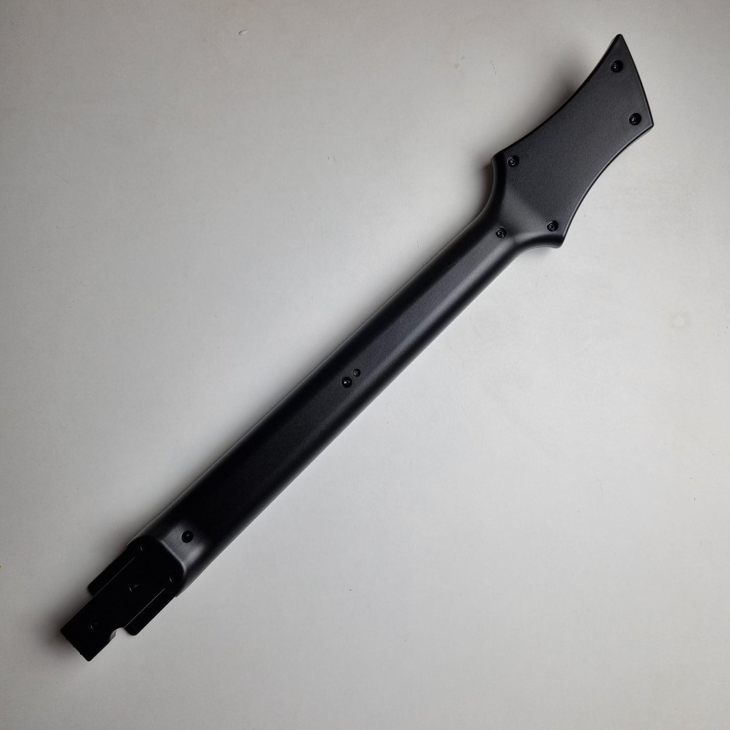 Black neck of a official RedOctane Nintendo Wii guitar controller on a white background.