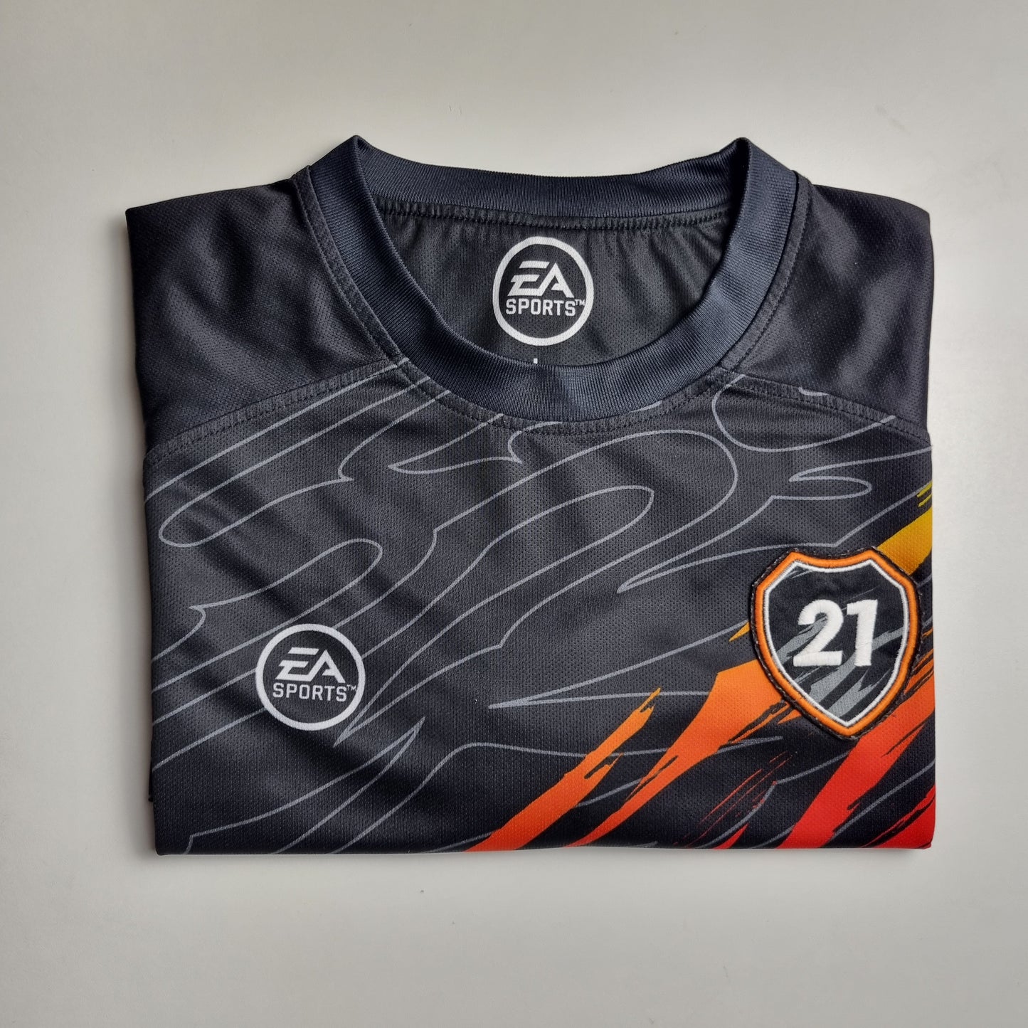Folded sports jersey with EA Sports logo on a grey background