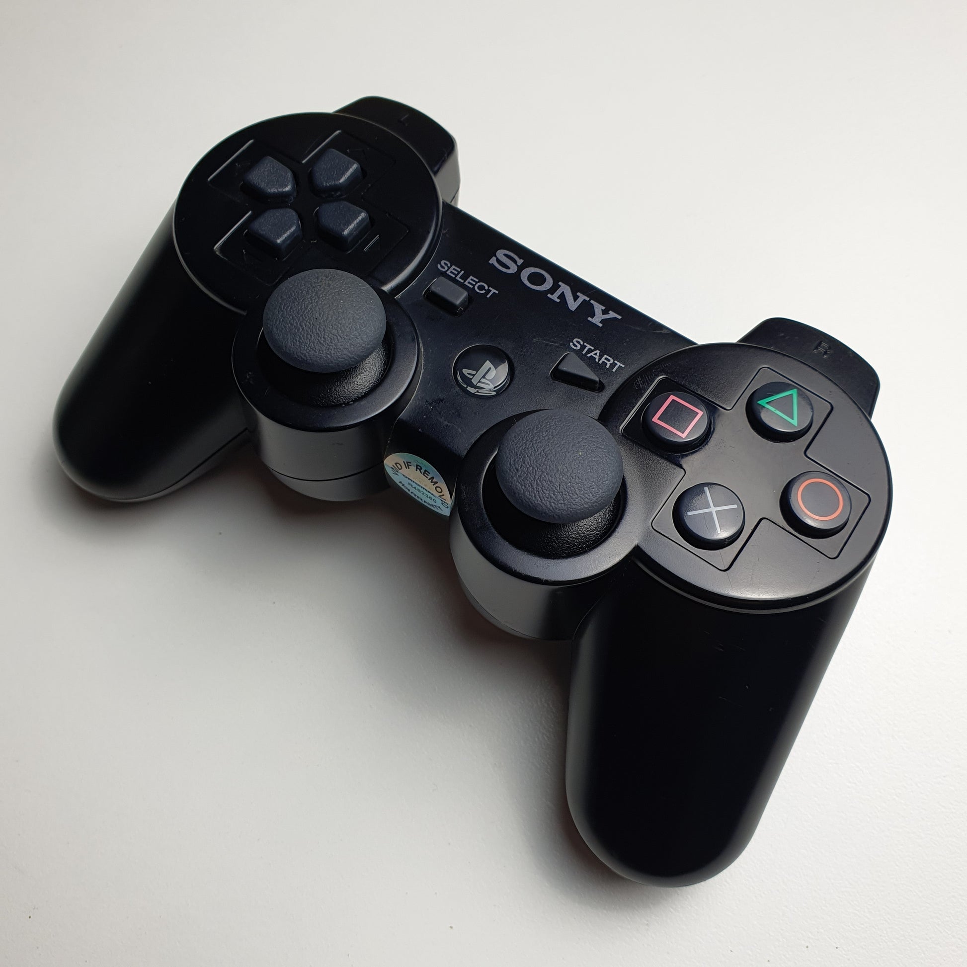 Black PlayStation 3 controller with Sony logo on a white background