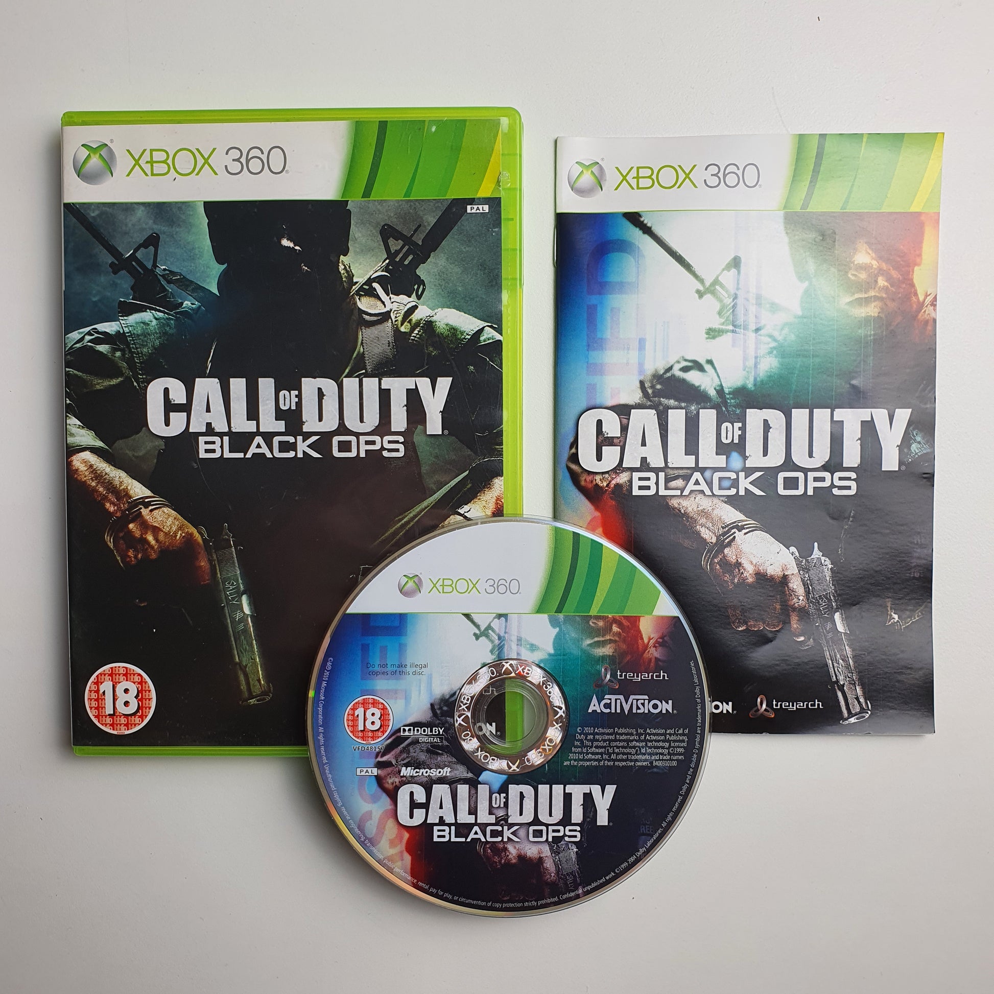 Call of Duty Black Ops game case, disc and manual on a white background