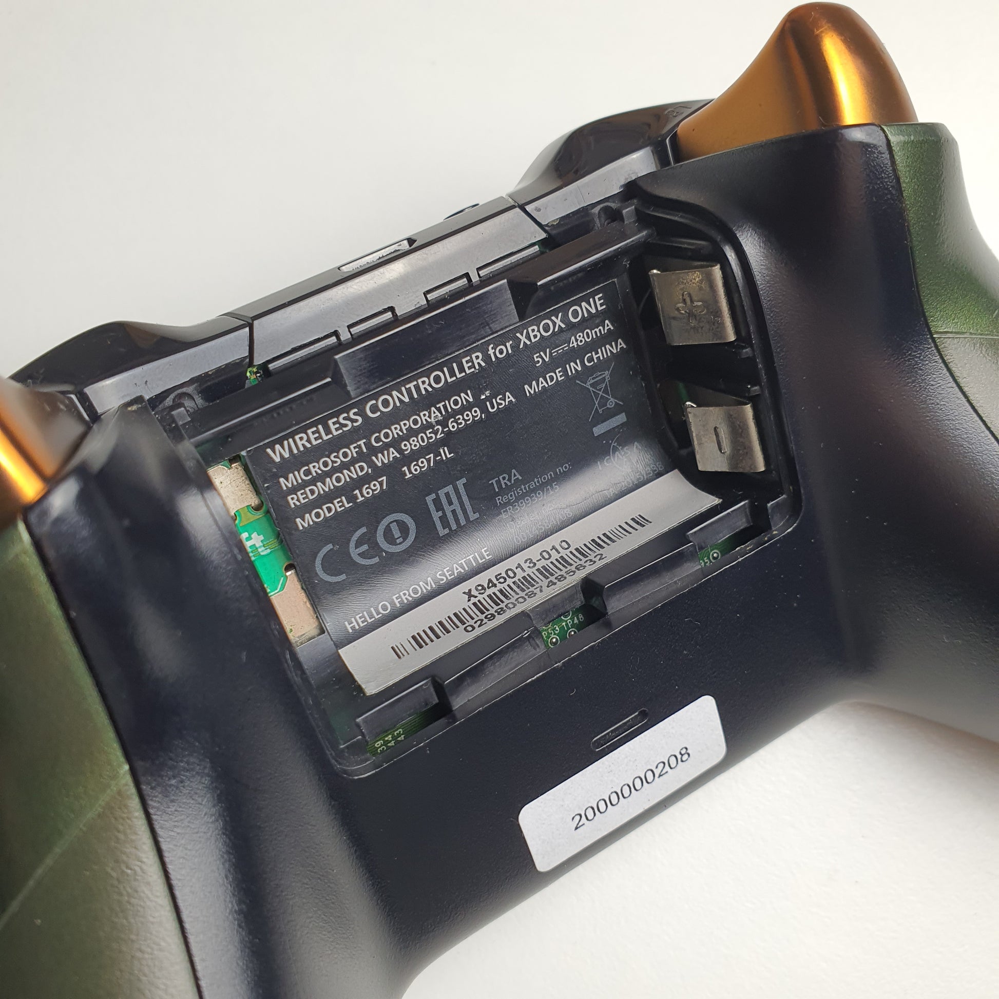 Close-up of a battery compartment with visible branding on a white background