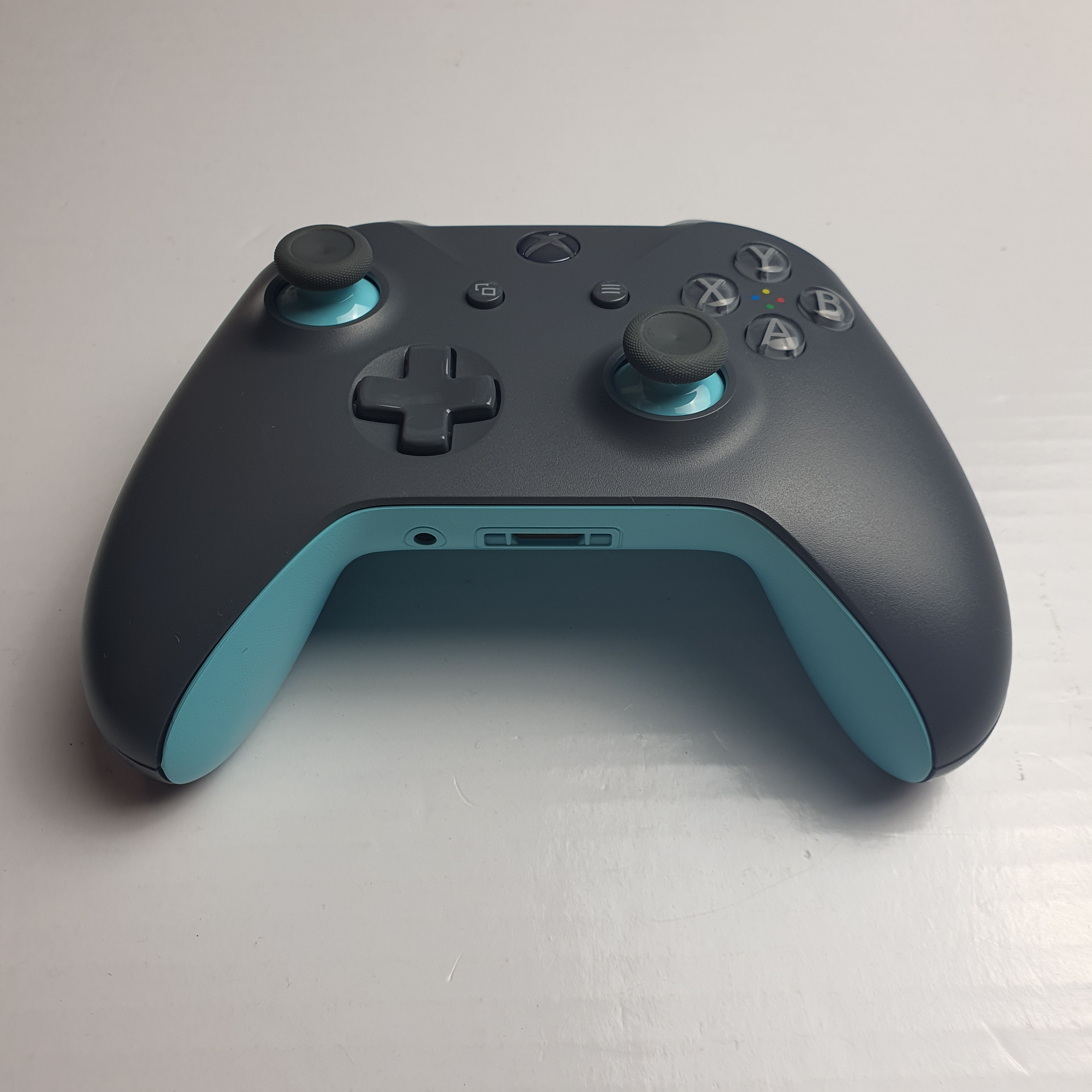 Microsoft official xbox grey store and blue wireless controller